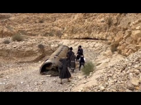 Jewish Ultra-Orthodox families inspect debris of what’s believed to be an intercepted Iranian surfac [Video]