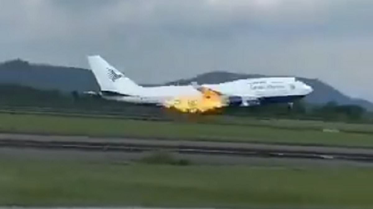Moment flames shoot from the back of a Boeing 747 carrying 468 passengers in Indonesia in latest troubling incident for plane-making giant - amid fears safety crisis could spark jet shortage and hit holiday getaways [Video]